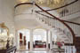 An impressive staircase is the focal point of this grand foyer.